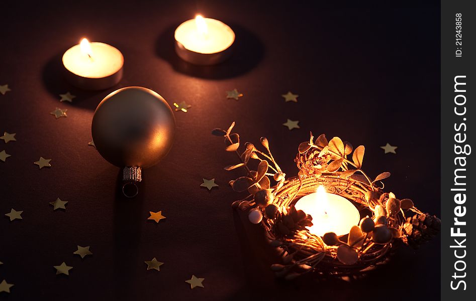 Christmas candles and ball with star confetti