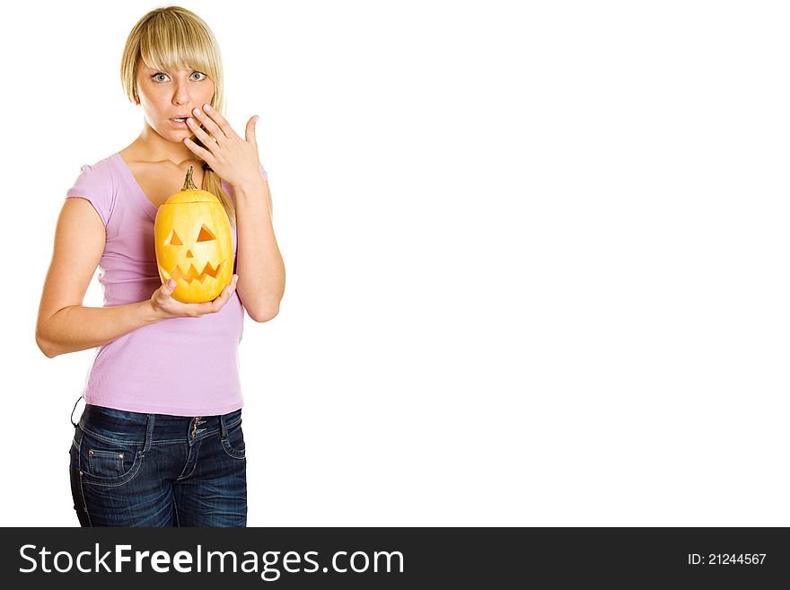 Young woman frightened with pumpkin for Halloween. Lots of copyspace and room for text on this isolate. Young woman frightened with pumpkin for Halloween. Lots of copyspace and room for text on this isolate