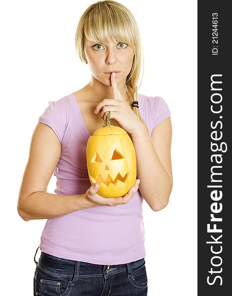 Young woman frightened with pumpkin for Halloween. Gesturing for Quiet or Shushing. Lots of copyspace and room for text on this isolate. Young woman frightened with pumpkin for Halloween. Gesturing for Quiet or Shushing. Lots of copyspace and room for text on this isolate