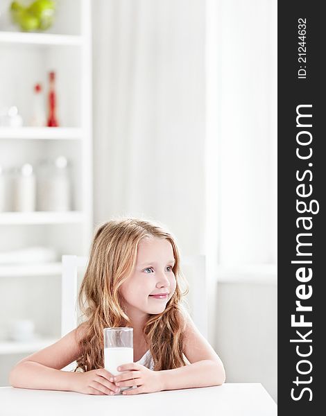 Beautiful little girl with a glass of milk. Beautiful little girl with a glass of milk