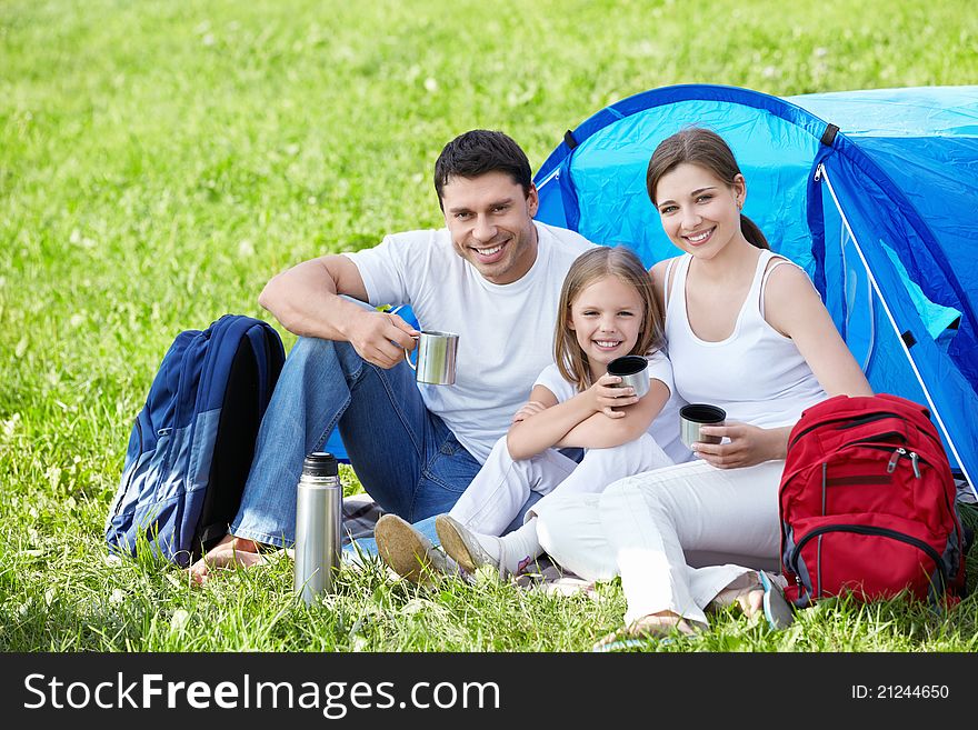 A happy family with a tent. A happy family with a tent