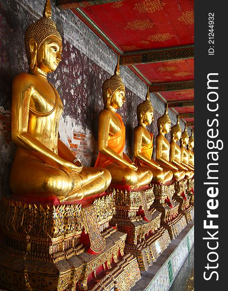 A Row Of Golden Buddha Statue At Wat Suthat IN Thailand