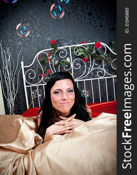 Portrait of happiness woman on vintage bed. Portrait of happiness woman on vintage bed