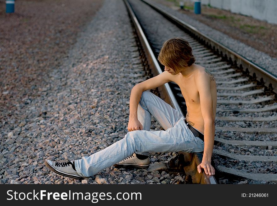 Handsome man walking near rails