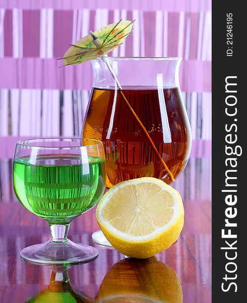 Color photo of a glass cup with a cocktail and lemon