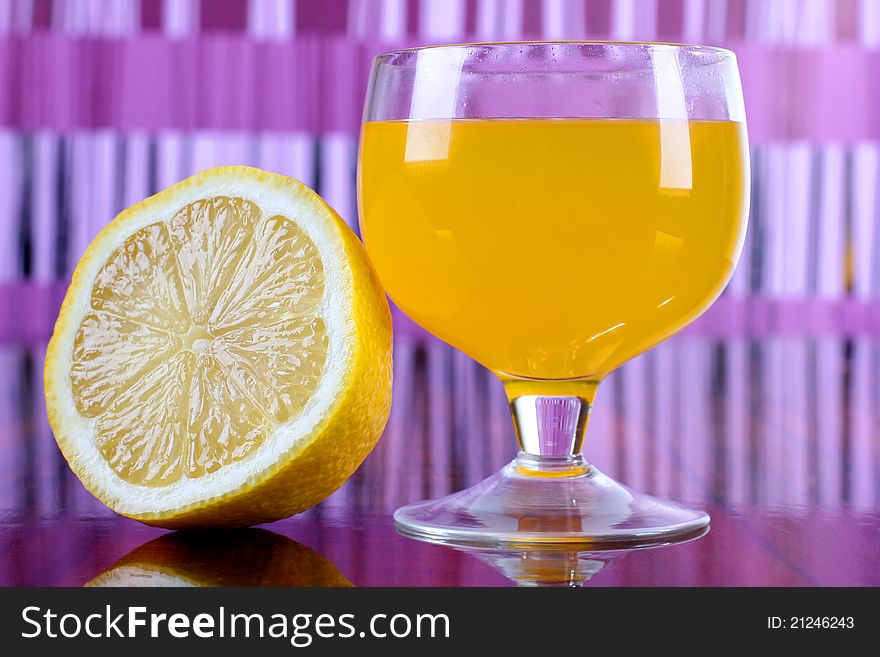 Color photo of a glass cup with a cocktail and lemon. Color photo of a glass cup with a cocktail and lemon