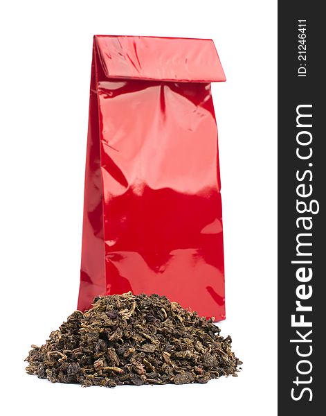 Heap of black tea and tea package