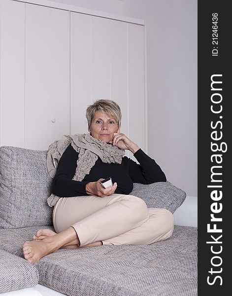 Attentive woman in television sitting on couch