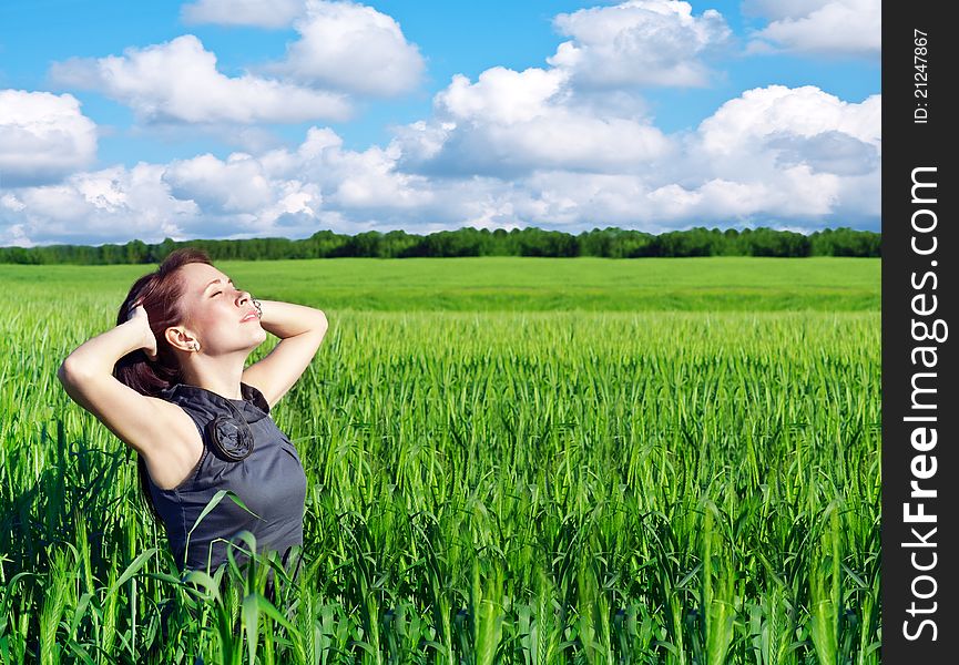 Young woman with hands raised up in the wheat field. Young woman with hands raised up in the wheat field