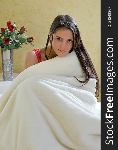 Girl sitting wrapped in a blanket