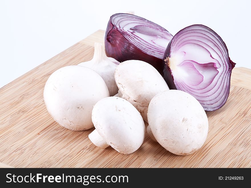 Field mushrooms on a wooden board. Salad