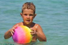 Boy In The Water Playing With A Ball Royalty Free Stock Photos