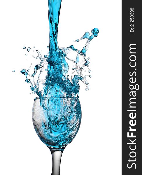 The dark blue liquid flows in a glass. The dark blue liquid flows in a glass