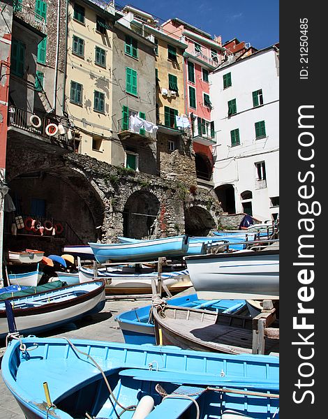 Colorful fishing boats in a small marina in one of the picturesque towns in Cinque Terre region in Ligurian coast. Colorful fishing boats in a small marina in one of the picturesque towns in Cinque Terre region in Ligurian coast.