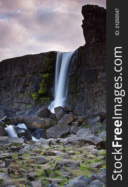 Þingvellir national park near Reykjavik is one of the most popular places of interest along so called Golden Ring - route from Reykjavik. This is where the American and Eurasian plates meet or better to say separate as they are drifting apart creating a canyon. This photo has been taken from below the Öxarárfoss waterfall. Þingvellir national park near Reykjavik is one of the most popular places of interest along so called Golden Ring - route from Reykjavik. This is where the American and Eurasian plates meet or better to say separate as they are drifting apart creating a canyon. This photo has been taken from below the Öxarárfoss waterfall.