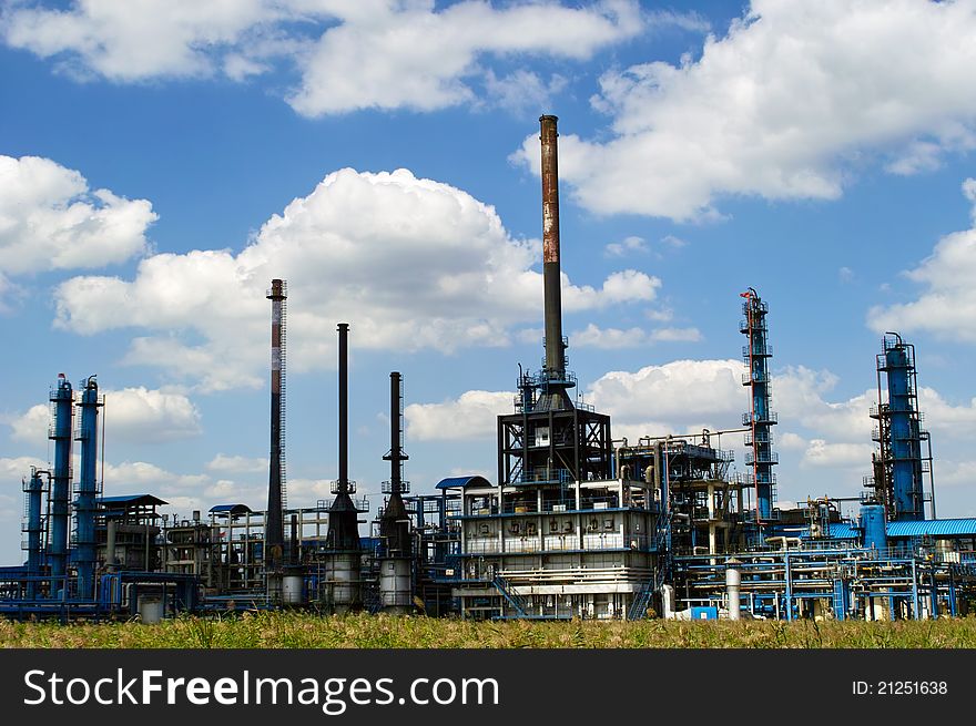 Oil refinery factory against blue sky