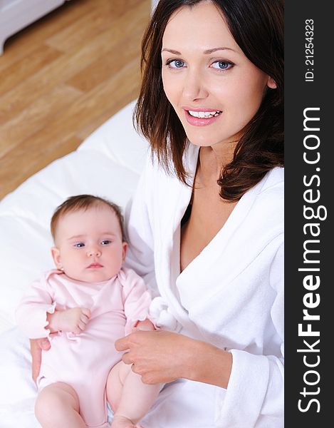 Portrait of happy young beautiful mother with little newborn baby - high angle. Portrait of happy young beautiful mother with little newborn baby - high angle