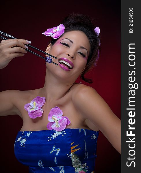 Portrait of young gorgeous asian woman with chopsticks. Portrait of young gorgeous asian woman with chopsticks