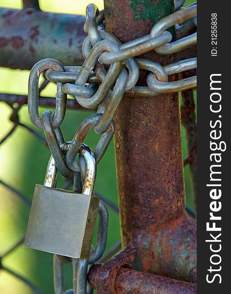 Padlock on a chain closing an entrance