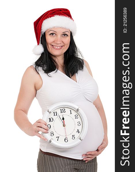 Portrait of a pregnant woman in santa hat with clock over white background. Third trimester. Portrait of a pregnant woman in santa hat with clock over white background. Third trimester.