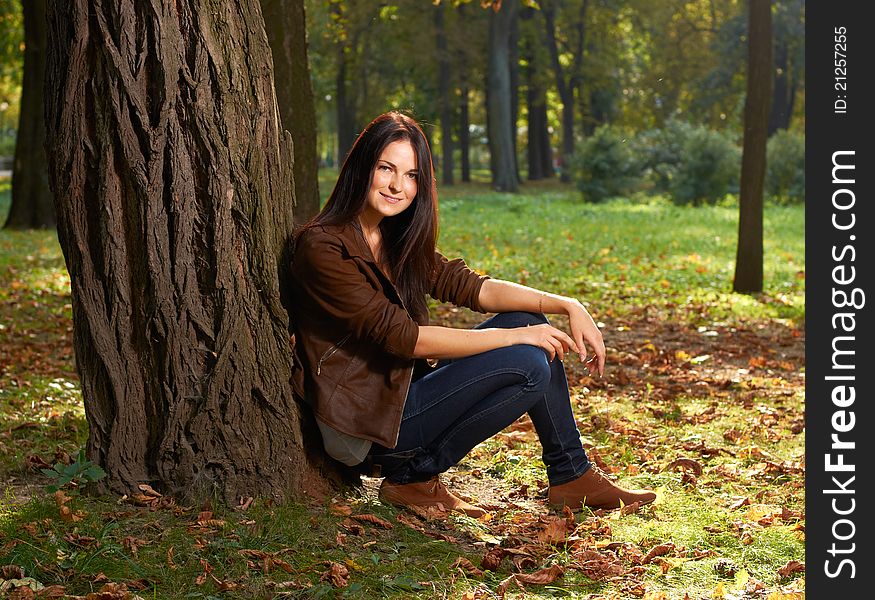 Portrait of young girl with trees in background. Portrait of young girl with trees in background