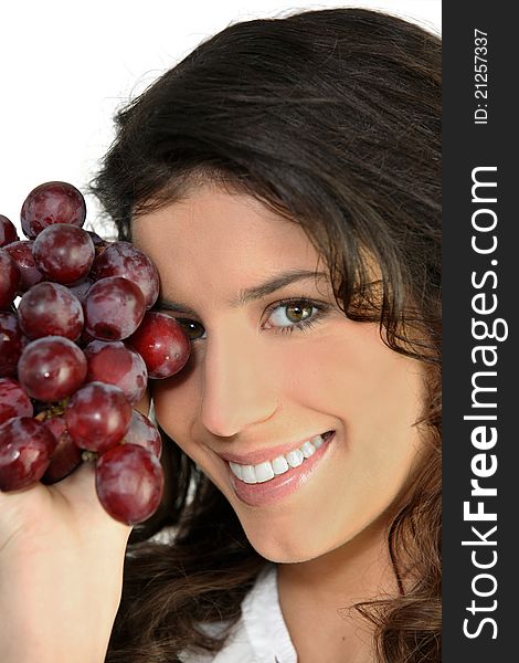 Portrait of a woman with bunch of ripe grapes