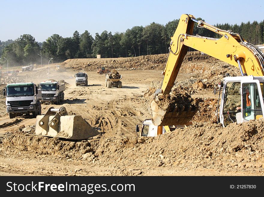 Excavator on a construction site of movement of ground and rock. Excavator on a construction site of movement of ground and rock.