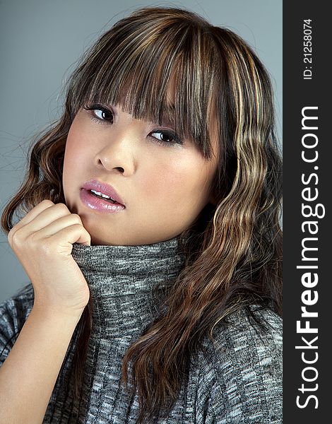 Portrait of young asian woman in sweater. Portrait of young asian woman in sweater