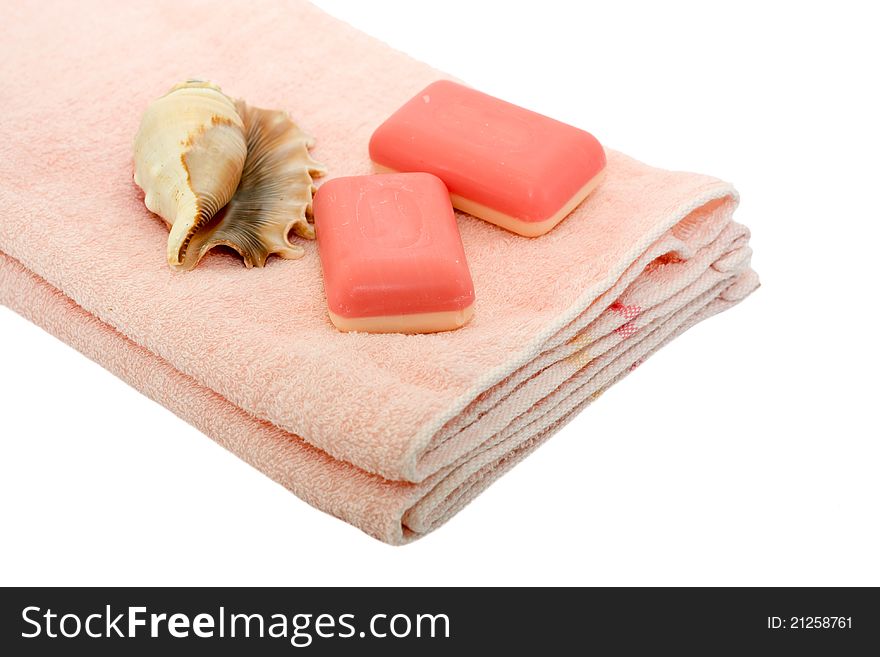 Pink towel and soap with shells isolated on a white background. Pink towel and soap with shells isolated on a white background