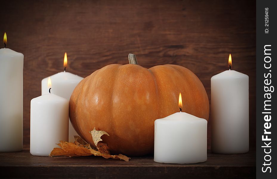 Pumpkin with candels on the wooden background