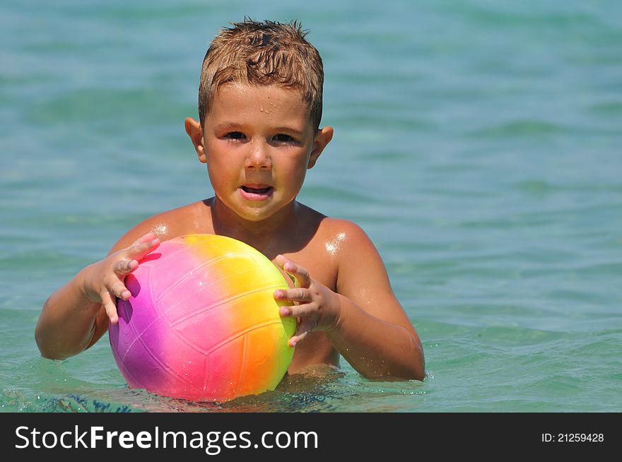 Boy in the water playing with a ball