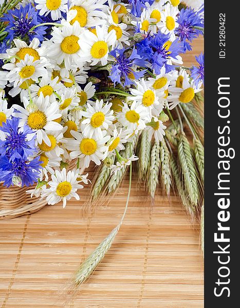 Beautiful flowers in a basket on bamboo background