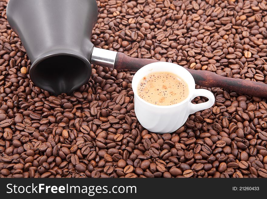 Cup of fresh coffee against coffee grains. Cup of fresh coffee against coffee grains