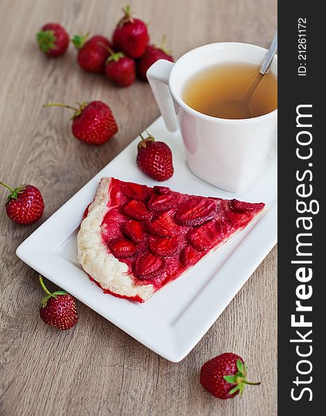 Close-up homemade strawberry pie and a cup of tea