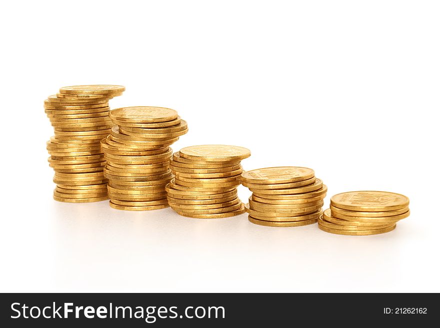 Side view of stacks of coins increasing in height, on white studio background. Side view of stacks of coins increasing in height, on white studio background