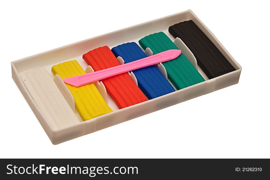 Color children's plasticine lies on a white background