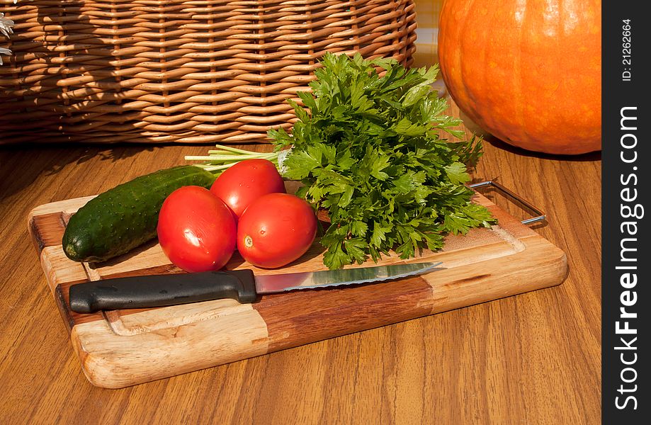 The suite from summer vegetables for salad luing on the wooden board. The suite from summer vegetables for salad luing on the wooden board