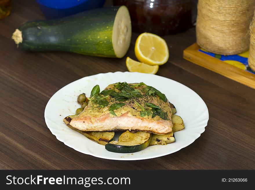 Tasty salmon filet on a white plate, with grilled vegetables. Tasty salmon filet on a white plate, with grilled vegetables