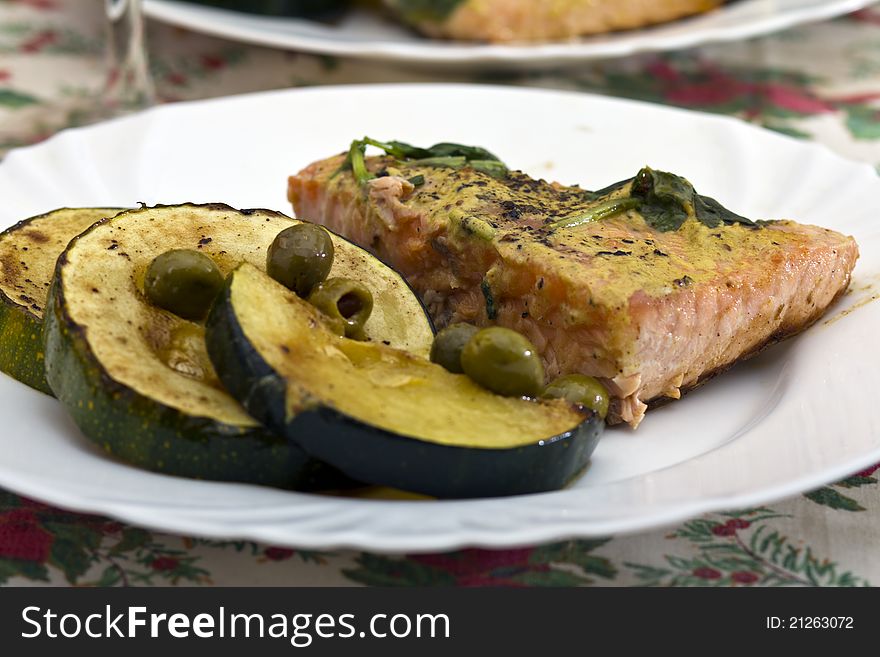 Tasty salmon filet on a white plate, with grilled vegetables. Tasty salmon filet on a white plate, with grilled vegetables