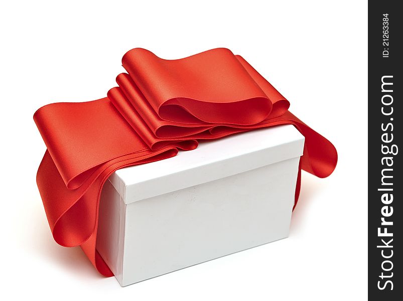 Gift wrapped with a red ribbon on a white background. Gift wrapped with a red ribbon on a white background