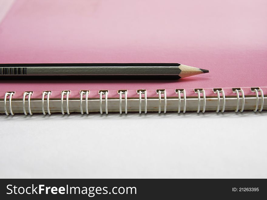 Notebook on the white with pencils. Notebook on the white with pencils.