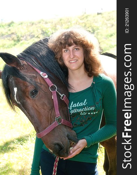 Outdoor portrait of the young smiling girl and horse. Outdoor portrait of the young smiling girl and horse