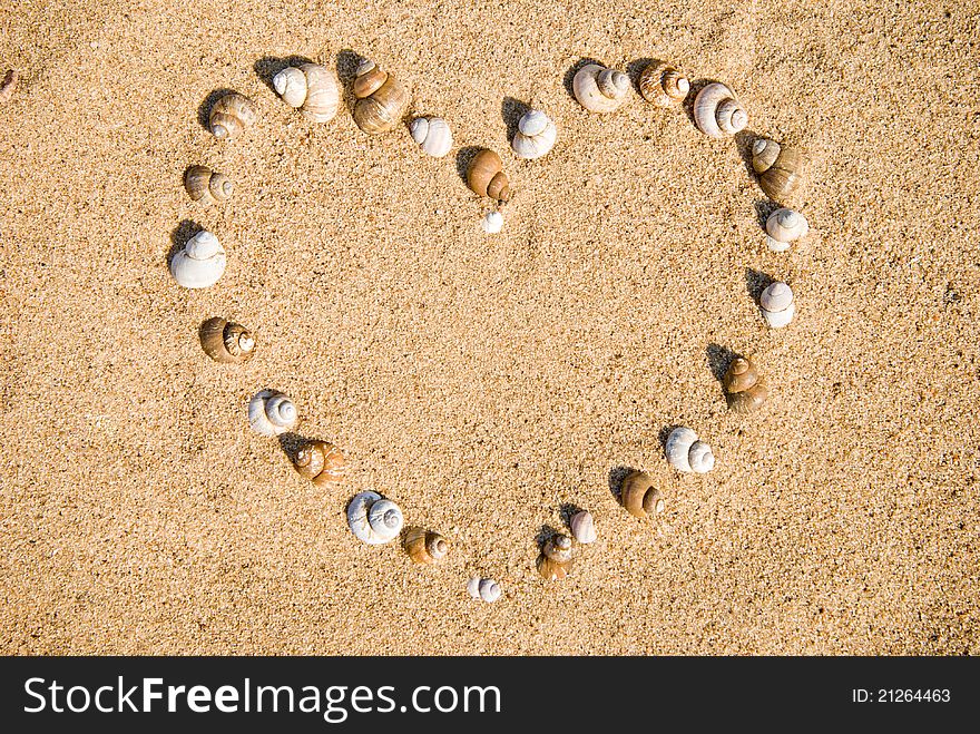 Image of the heart on sand. Ð¡ockleshells. Image of the heart on sand. Ð¡ockleshells.