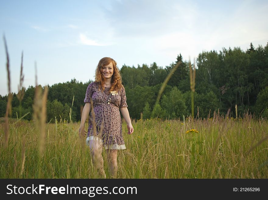 Beautiful pregnant girl on the field