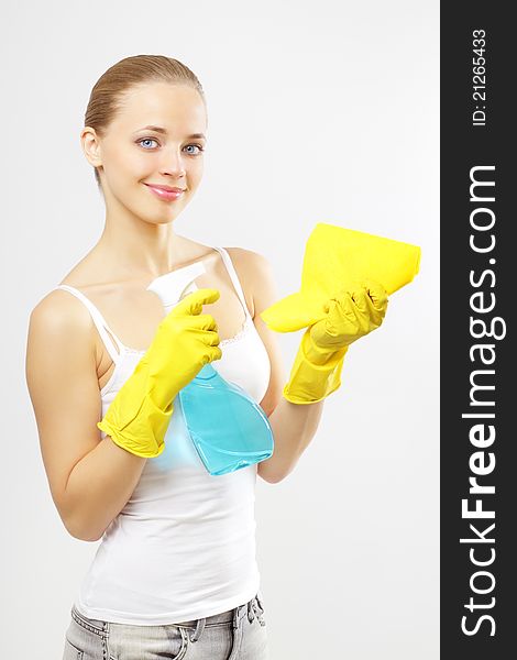 Woman holding glass cleaner and rag. gray background. Woman holding glass cleaner and rag. gray background