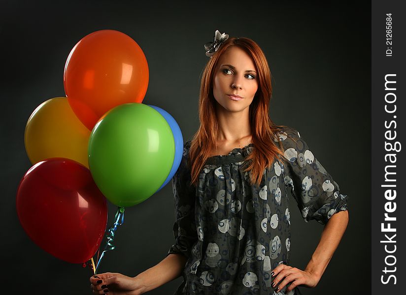 Woman with balloons on grey background