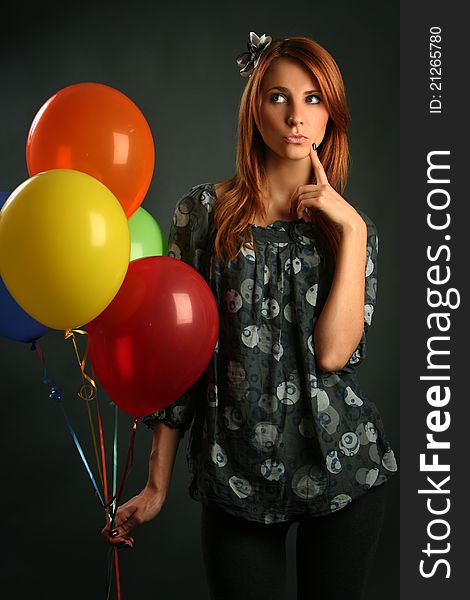 Woman with balloons on grey background. Woman with balloons on grey background