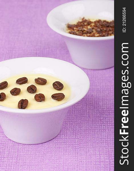 Cream servings with coffee beans and chocolate flakes