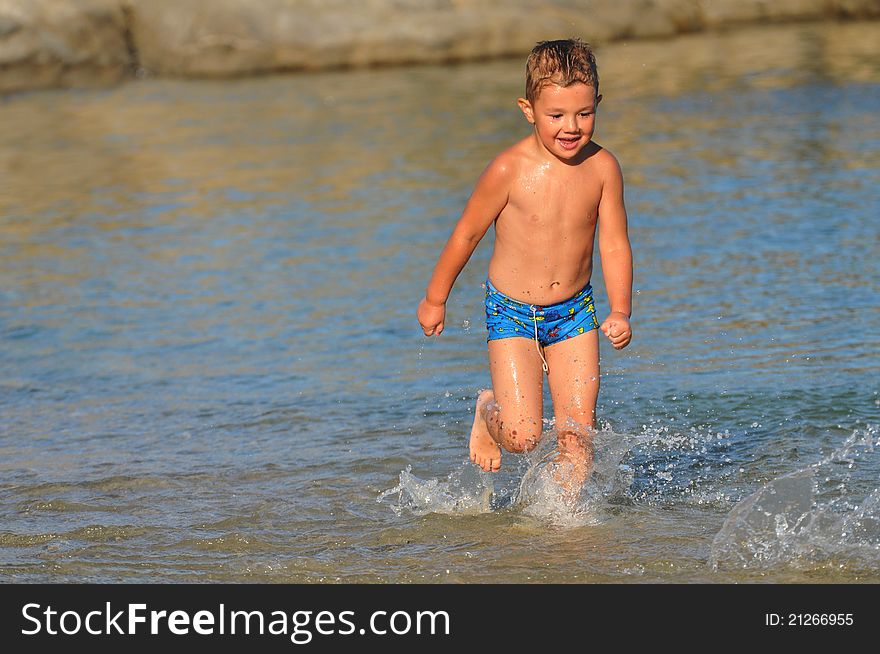 Boy running down the beach,recreation