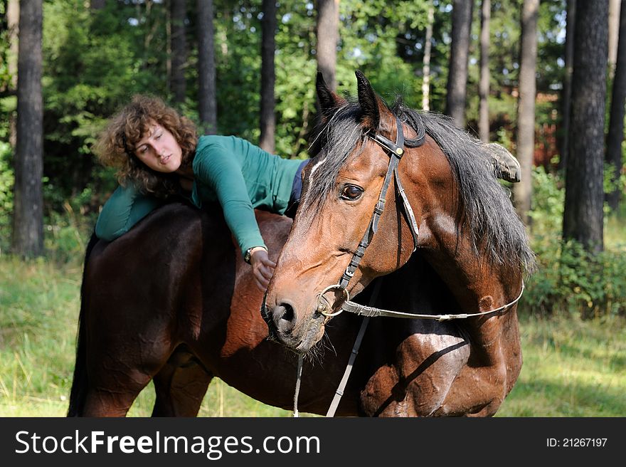 Girl liying on horseback and coomunicating with her horse. Girl liying on horseback and coomunicating with her horse